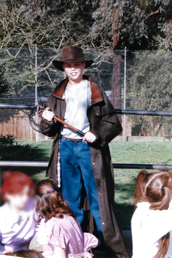 Young Adam in full Indiana Jones gear holding a whip